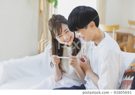 A couple who is happy to have a positive reaction with a pregnancy test drug 93805691