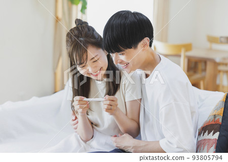 A couple who is happy to have a positive reaction with a pregnancy test drug A couple who is happy to have a positive reaction with a pregnancy test drug 93805794