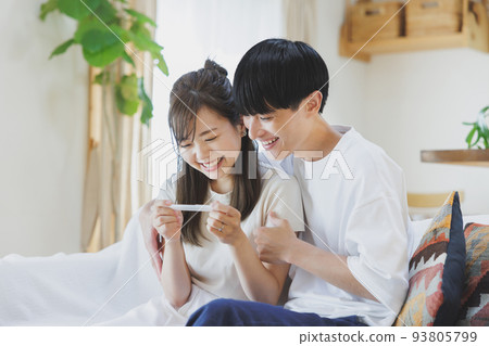 A couple who is happy to have a positive reaction with a pregnancy test drug A couple who is happy to have a positive reaction with a pregnancy test drug 93805799