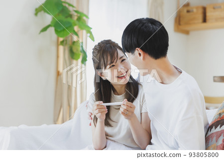 A couple who is happy to have a positive reaction with a pregnancy test drug A couple who is happy to have a positive reaction with a pregnancy test drug 93805800