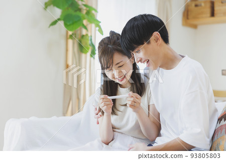 A couple who is happy to have a positive reaction with a pregnancy test drug A couple who is happy to have a positive reaction with a pregnancy test drug 93805803