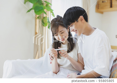 A couple who is happy to have a positive reaction with a pregnancy test drug A couple who is happy to have a positive reaction with a pregnancy test drug 93805805