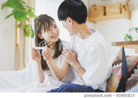 A couple who is happy to have a positive reaction with a pregnancy test drug 93805823