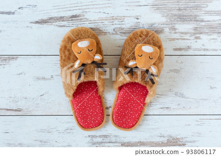 Cozy Christmas slippers on wooden parquet top view. Cozy Christmas slippers on wooden parquet top view. 93806117