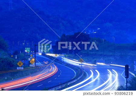 Road and light trails at sunset 93806219