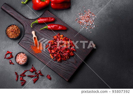 Pieces of dried paprika, preparation of powder spice for various dishes 93807392