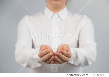 Close-up of female hands with palms up. Close-up of female hands with palms up. 93807760