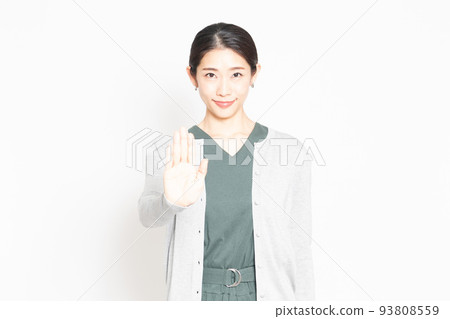 A woman who makes an NG gesture in front of a white background 93808559