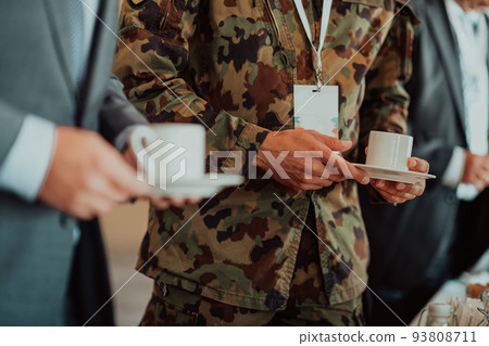 Close-up photo of soldier serving themselves in a modern hotel during a dinner party. Selective focus Close-up photo of soldier serving themselves in a modern hotel during a dinner party. Selective focus 93808711