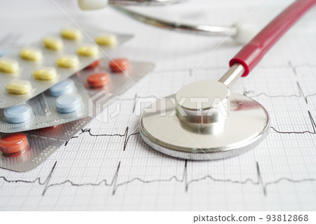 Stethoscope on electrocardiogram (ECG) with drug, heart wave, heart attack, cardiogram report. 93812868