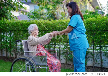 Doctor help Asian elderly woman disability patient sitting on wheelchair in park, medical concept. 93813421