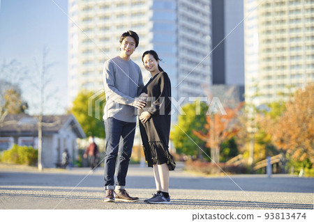 A couple walking in coats A couple walking in coats 93813474