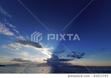 Summer coastal evening view with cumulonimbus clouds blocking the setting sun, ultra-wide angle, mainly sky, 220706pm Summer coastal evening view with cumulonimbus clouds blocking the setting sun, ultra-wide angle, mainly sky, 220706pm 93813783