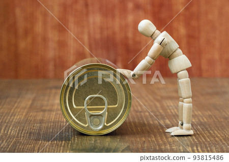 Wooden figurine of a man pushing a tin can 93815486