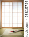 A red Japanese sword placed in a Japanese-style room with shoji screens 93815726