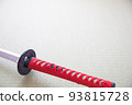 A red Japanese sword placed in a Japanese-style room 93815728
