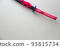 A red Japanese sword placed in a Japanese-style room 93815734