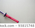 A red Japanese sword placed on a tatami mat 93815748