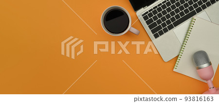 Flat lay laptop, coffee cup, notepad and microphone for podcasts on pink background. Copy space for your text 93816163