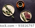 delicious steak and rosemary branch on white plate 93816797