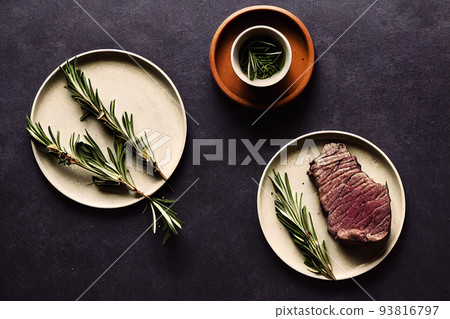 delicious steak and rosemary branch on white plate delicious steak and rosemary branch on white plate 93816797