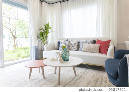 Red, blue and white pillows on a white sofa, living room interior. Red, blue and white pillows on a white sofa, living room interior. 93817821