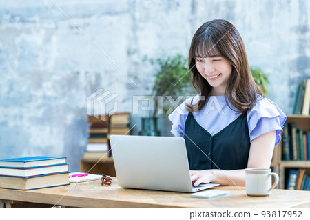 A woman using a laptop in a chic room 93817952