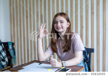 Girl is doing homework in the Classroom. Back to school! 93818505