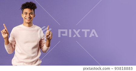 Waist-up portrait of joyful good-looking hispanic man with dreads, promoting product or company banner hanging on top, pointing fingers up, smiling satisfied, recommend subscribe or click link Waist-up portrait of joyful good-looking hispanic man with dreads, promoting product or company banner hanging on top, pointing fingers up, smiling satisfied, recommend subscribe or click link 93818883
