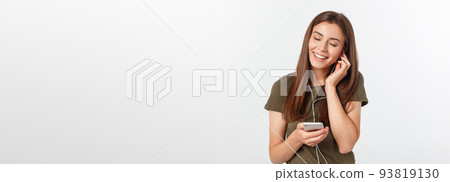 Portrait of a cheerful cute woman listening music in headphones and dancing isolated on a white background. Portrait of a cheerful cute woman listening music in headphones and dancing isolated on a white background. 93819130