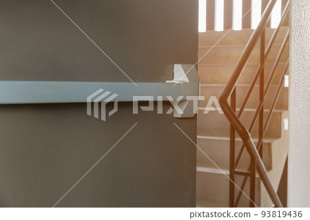 Emergency fire exit door. Closed up latch and rusty door handle of emergency exit. Emergency fire exit door. Closed up latch and rusty door handle of emergency exit. 93819436