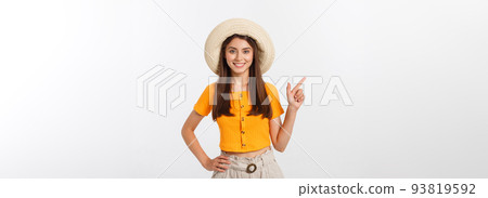 Teenager girl on summer vacation surprised and pointing finger on copy space over isolated white background. 93819592