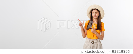 young pretty woman looking unhappy and stressed, suicide gesture making gun sign with hand, pointing to copy space. 93819595