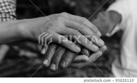Hands of the old man and a man hand black and white 93820110