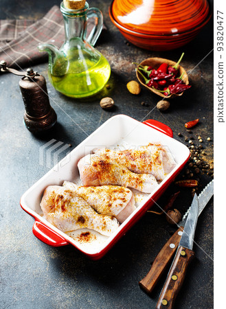 Raw uncooked chicken legs, drumsticks in bowl, meat with ingredients for cooking Raw uncooked chicken legs, drumsticks in bowl, meat with ingredients for cooking 93820477