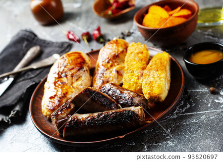 Sausages, chicken, fish fried with spices and herbs, Selective focus Sausages, chicken, fish fried with spices and herbs, Selective focus 93820697