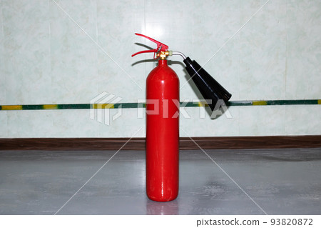 Red fire extinguisher in the room closeup Red fire extinguisher in the room closeup 93820872