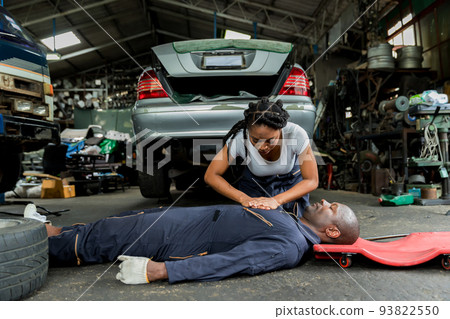 First aid support accident at work of worker at garage. First aid support accident at work of worker at garage. 93822550