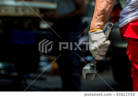 Wrench in Hand of car mechanic. Hand holding a metal Wrench	 93822558