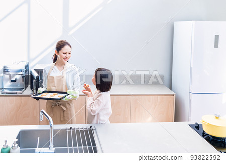 Elementary school students making cookies with mom Elementary school students making cookies with mom 93822592