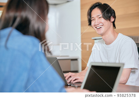 A young man having a conversation during telework 93825378