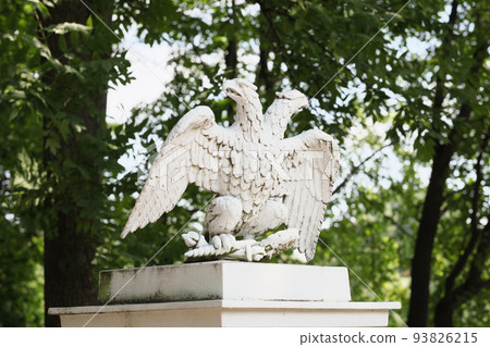 A double-headed eagle stone statue , the symbol of the Russian Federation. The architectural element of the gerden decor. A double-headed eagle stone statue , the symbol of the Russian Federation. The architectural element of the gerden decor. 93826215