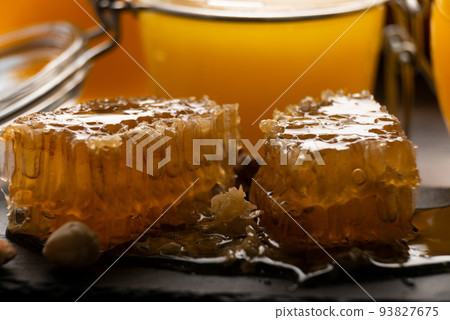 Honeycomb on slate tray on kitchen table macro view 93827675