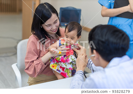 baby being checked by a doctor using a stethoscope. baby being checked by a doctor using a stethoscope. 93828279