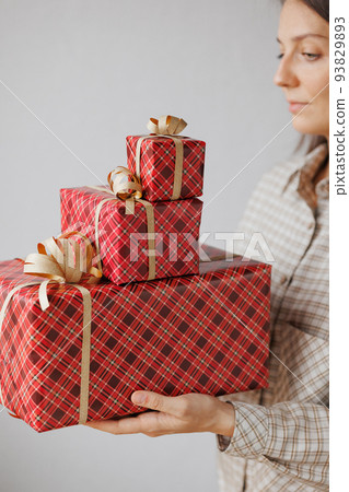 woman is holding boxes with gifts for Christmas, new year or birthday. Women's hands put give gifts 93829893