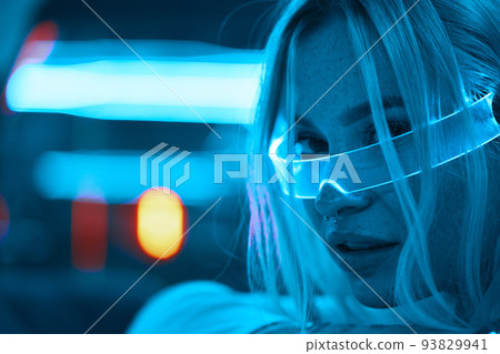 Young woman in neon glasses. Futuristic blonde. 93829941