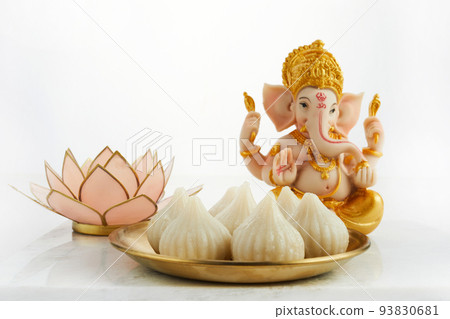 Idol of lord Ganesha with Modak Sweet Dish and flower. Ganesh chaturthi Idol of lord Ganesha with Modak Sweet Dish and flower. Ganesh chaturthi 93830681