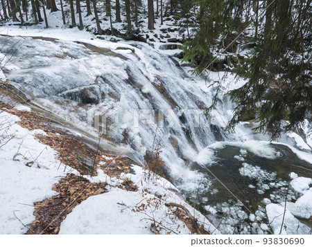 Mumlavsky vodopad, waterfall on Mumlava river stream in Krkonose National Park, Czech Republic in winter snow covered forest Mumlavsky vodopad, waterfall on Mumlava river stream in Krkonose National Park, Czech Republic in winter snow covered forest 93830690