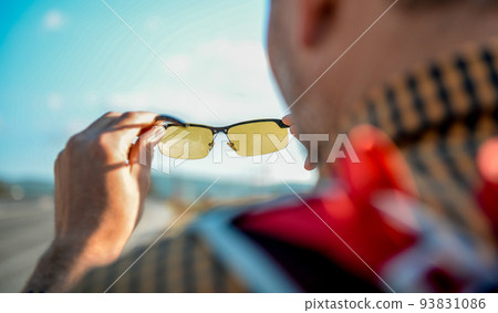 Man tourist look through glasses on beautiful nature. Abstract landscape view though eyeglasses. Blurry background. Vision concept Man tourist look through glasses on beautiful nature. Abstract landscape view though eyeglasses. Blurry background. Vision concept 93831086