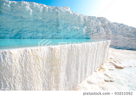 Blue outdoor pool in white rock. Natural travertine pools and terraces in Pamukkale. Cotton castle in southwestern Turkey. Vacation in beautiful nature. Sustainable 93831092